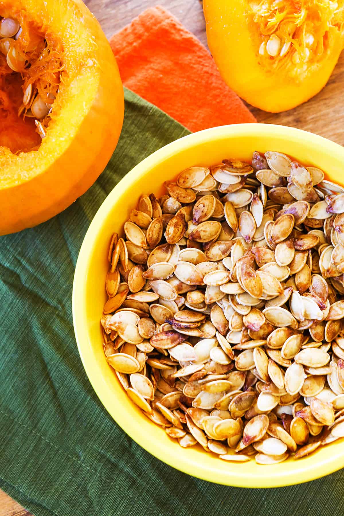 Top view of a bowl filled with roasted pumpkin seeds.