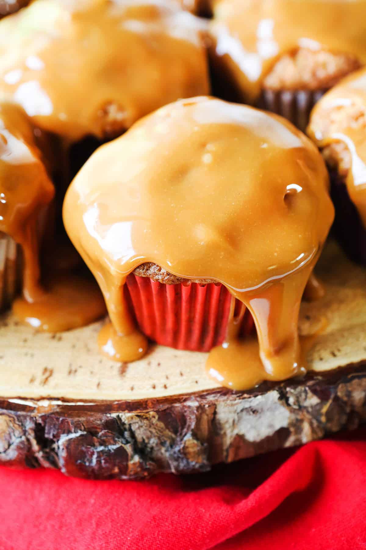 caramel apple cupcakes sitting on a rugged platter.