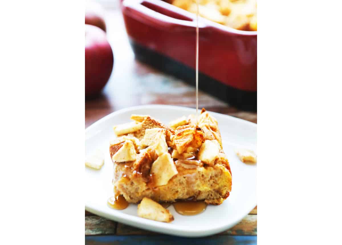 Syrup being drizzled over a piece of French toast bake with apples on top.