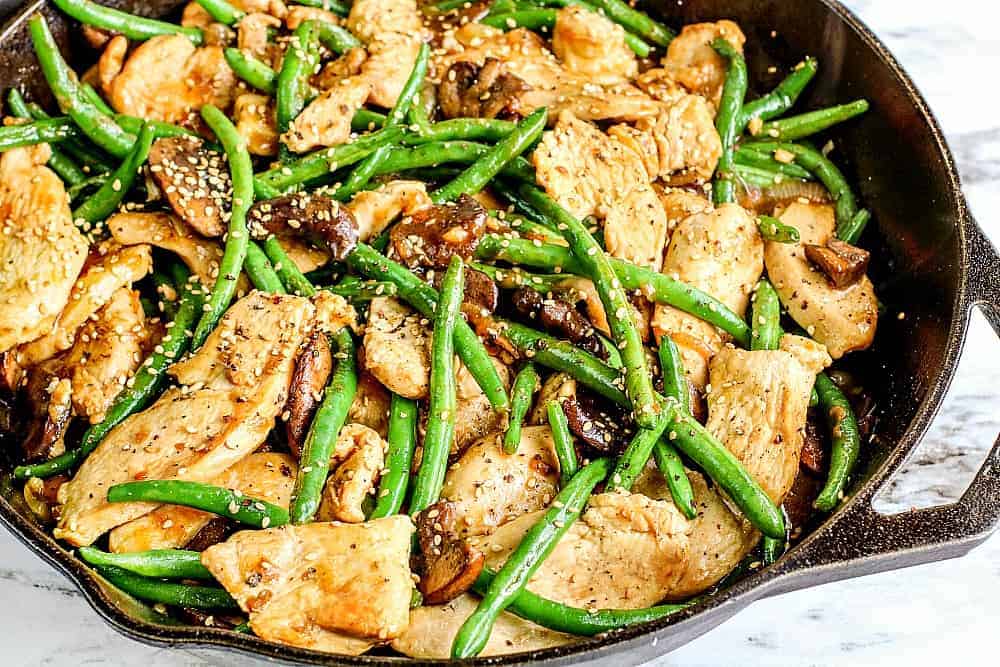 Skillet of chicken, mushrooms and green beans cooked and ready to serve. 