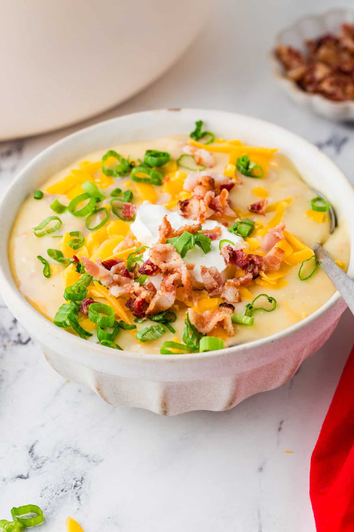Bowl of potato soup loaded with toppings.