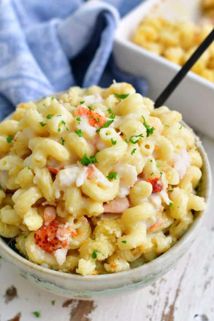 A bowl overflowing with lobster mac and cheese ready to serve. 
