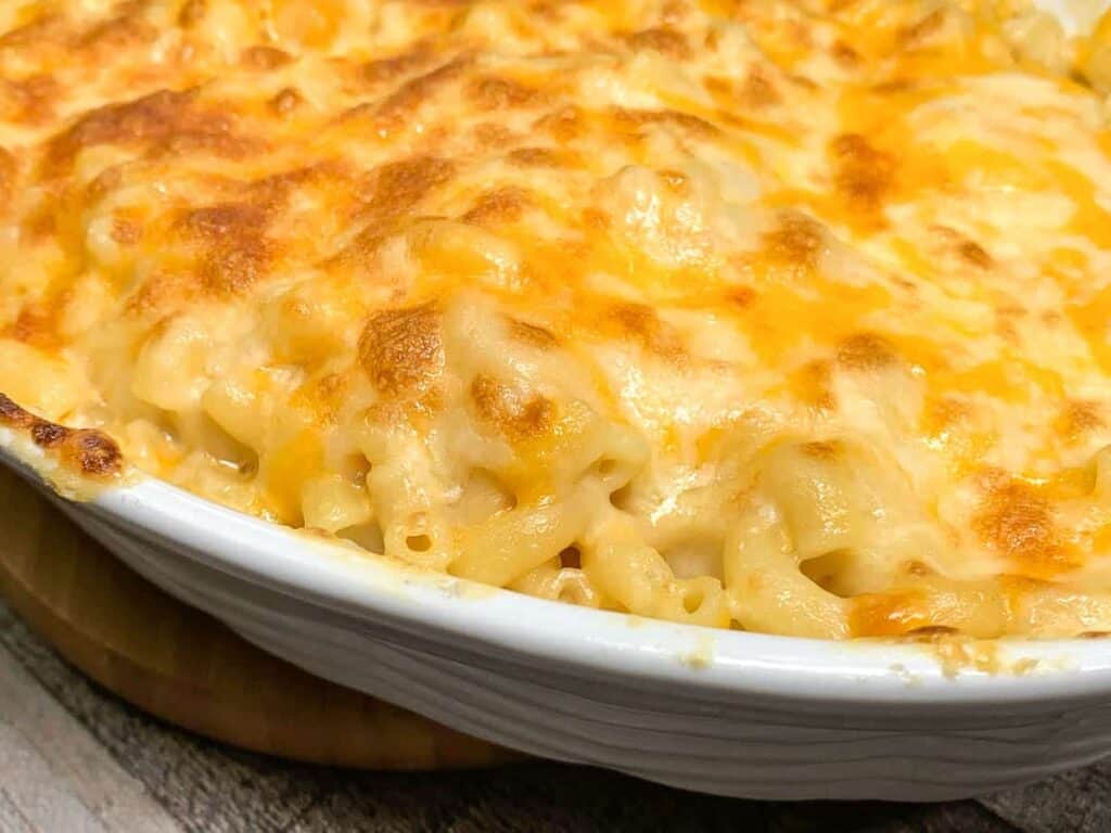 An oven dish with macaroni and cheese with melted cheese layered on top. 