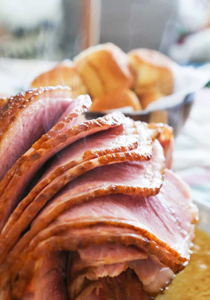 Crockpot ham sliced and slices falling open. 