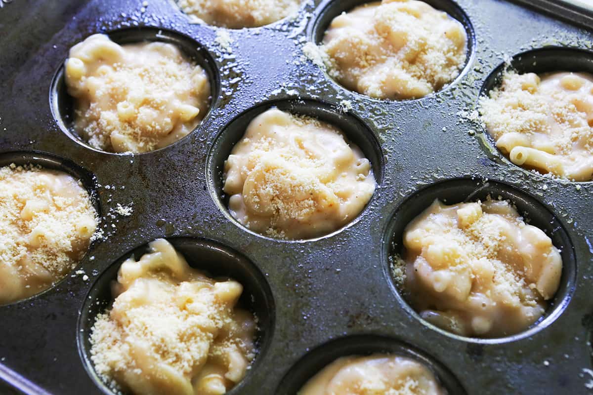 Mac and cheese in muffin tins, ready to bake.