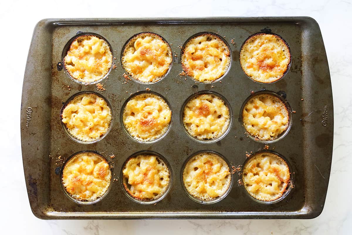 Top view of baked mac and cheese bites in a muffin tin.