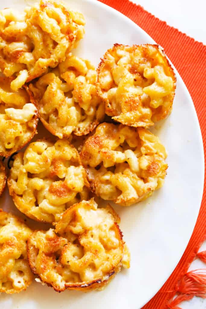 Baked mac and cheese bites served on a white plate. 