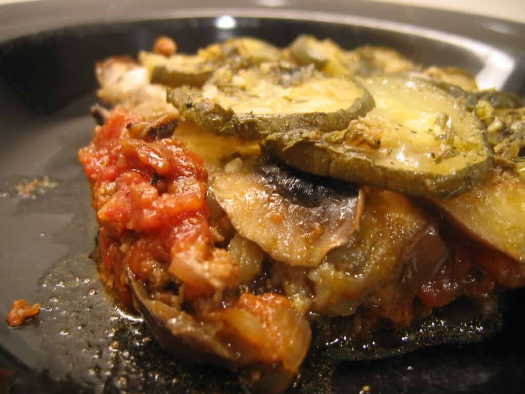 A serving of leftover spaghetti sauce moussaka sitting on a plate.