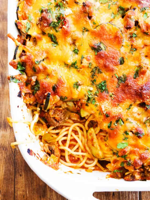 Casserole dish filled with baked spaghetti and a layer of cheese on top.