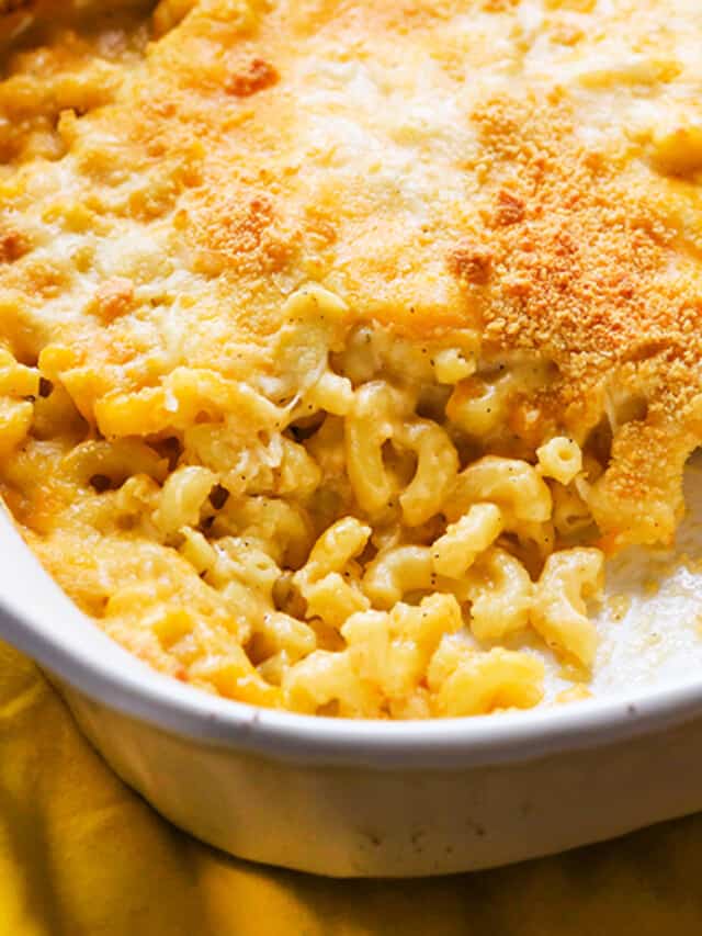 Baked mac and cheese in a baking dish with a spoonful removed.