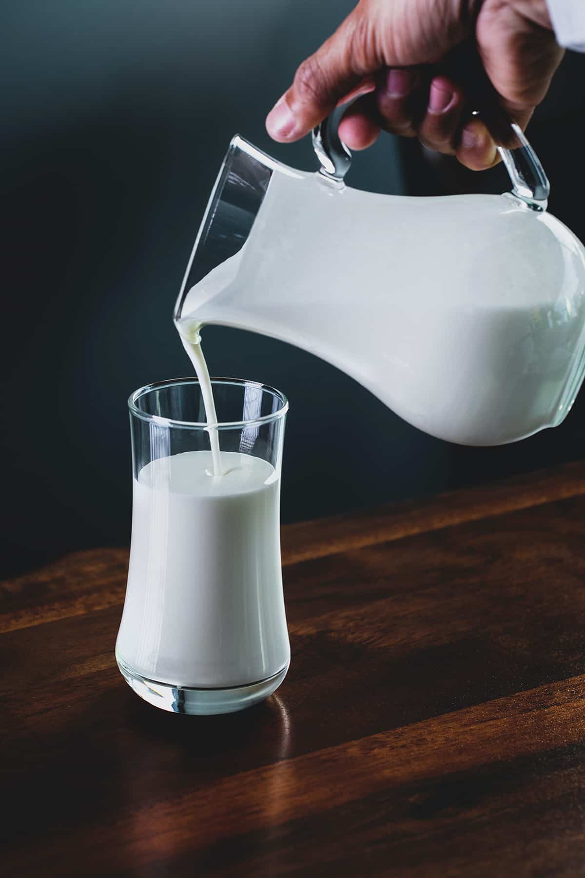 Heavy cream being poured into a glass.