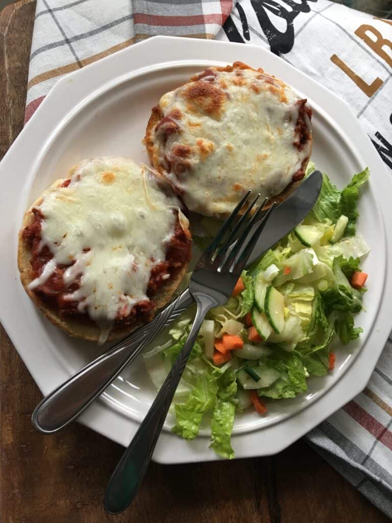Top view of a plate with Italian sloppy joes using leftover spaghetti and a garden salad. 