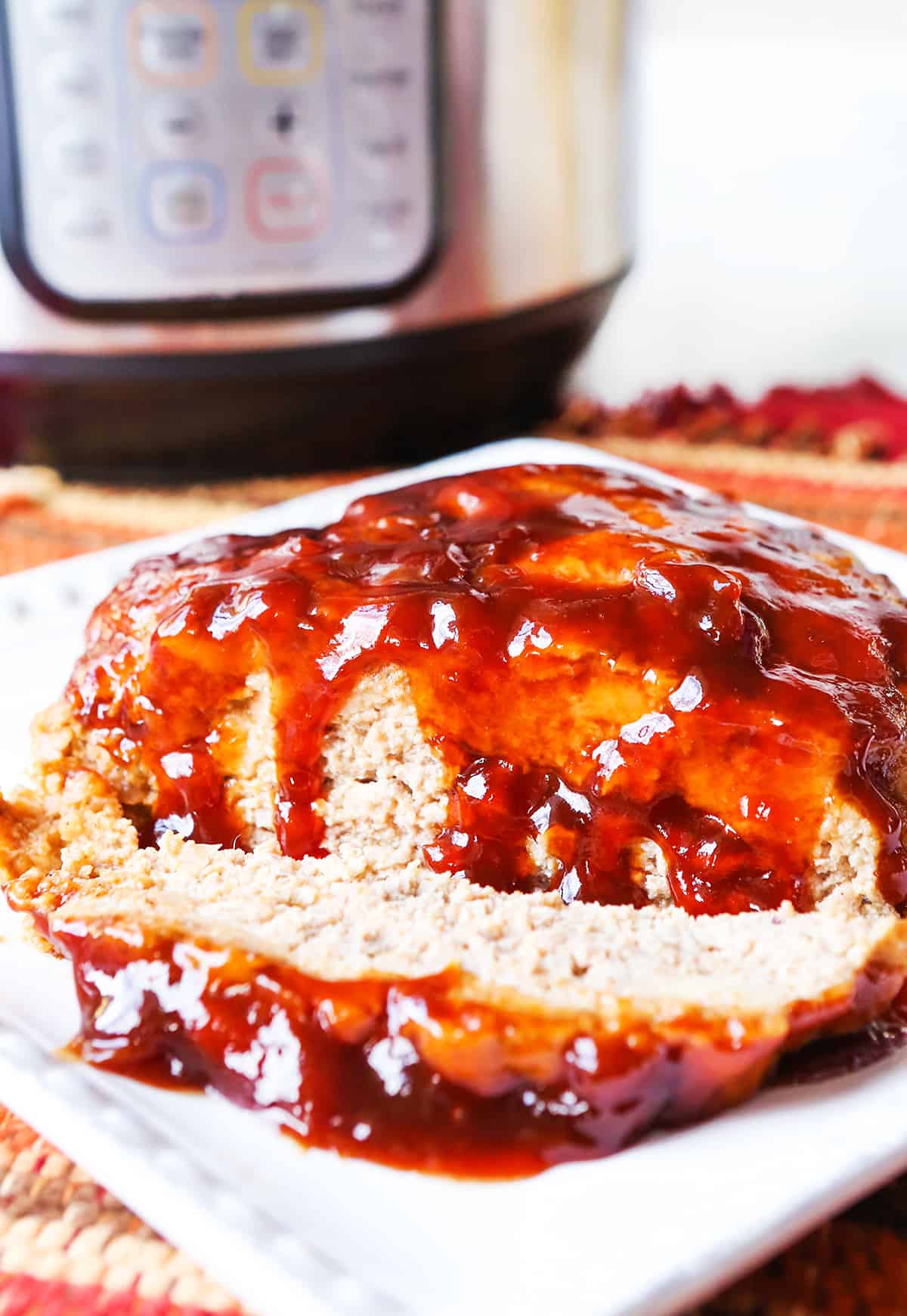 Delicious sauce dripping down sides of instant pot meatloaf. 