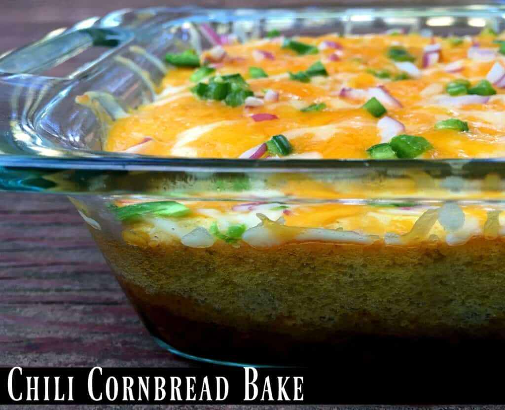 Partial view of a glass casserole dish with chili cornbread bake. 
