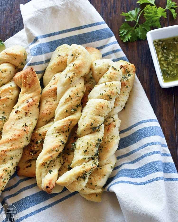 Spiral garlic bread sticks on a folded towel. 