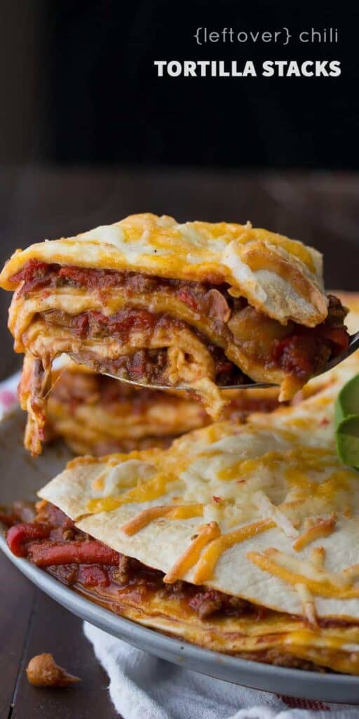 Leftover chili stack tortillas on a  spoon, hovering over a plate. 