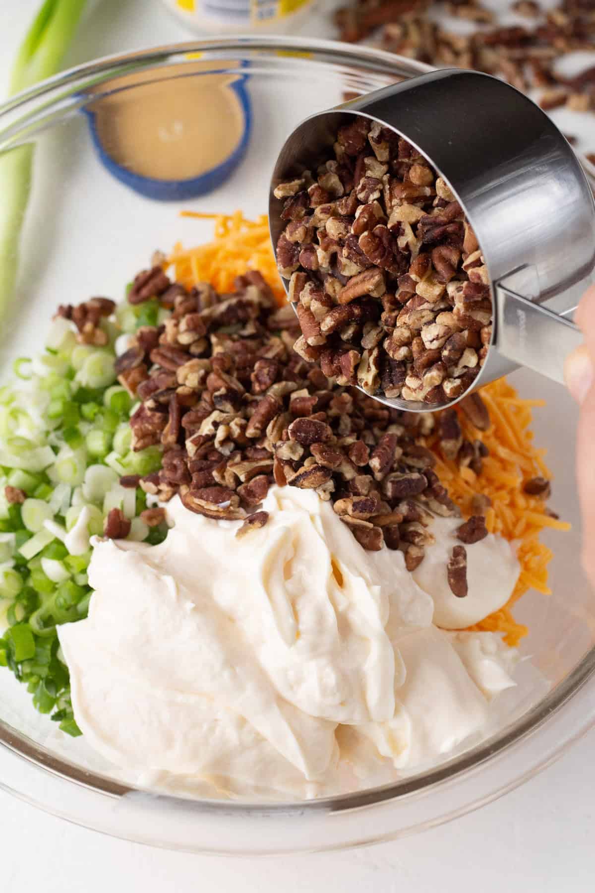 Cream cheese raspberry dip with chopped nuts and shredded cheese.