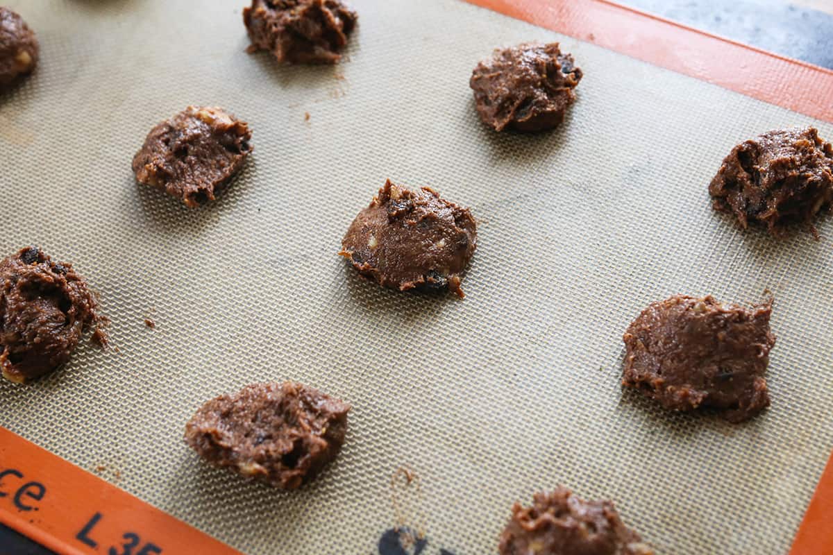 Cookie batter dropped onto a baking sheet, ready to bake.