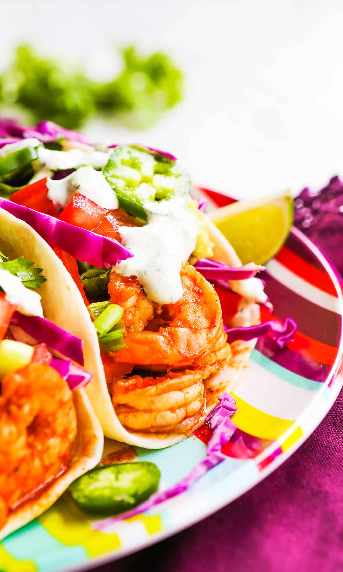 3 shrimp tacos on a plate.