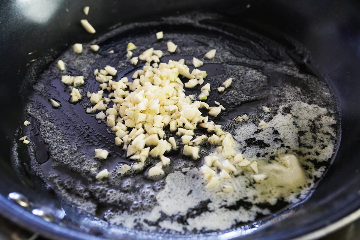 Minced garlic in a skillet with melted butter.