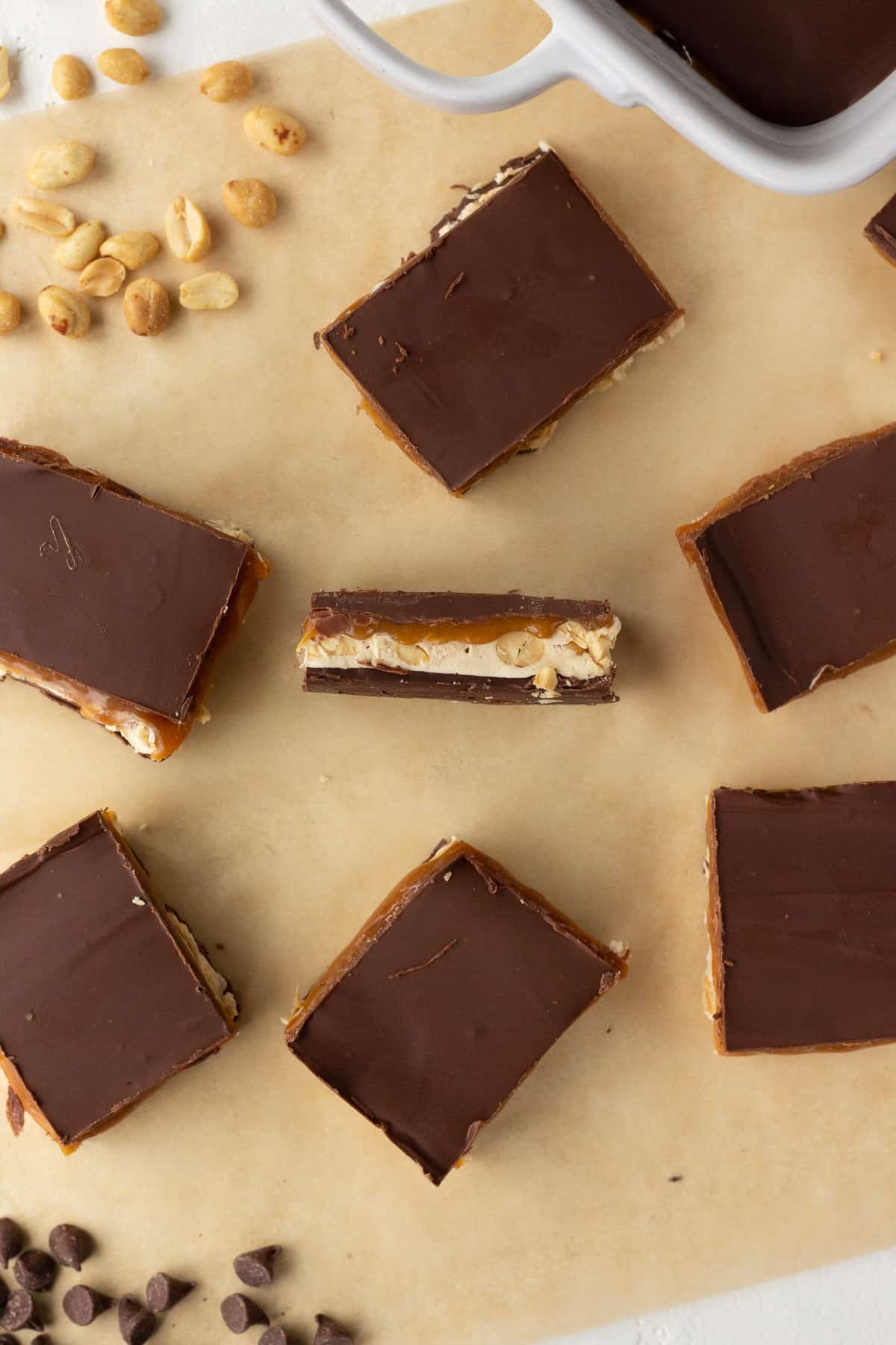 Top view of Snickers fudge lined up on parchment.