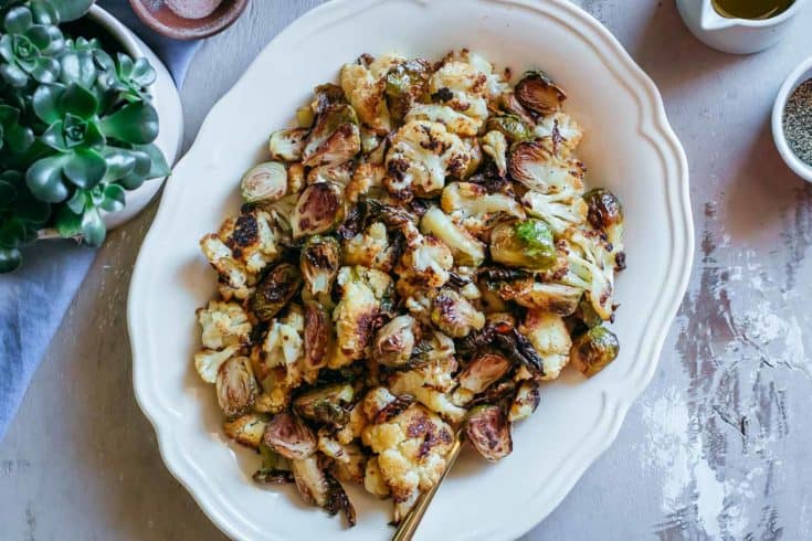 Serving plate of roasted brussels sprouts and cauliflower.