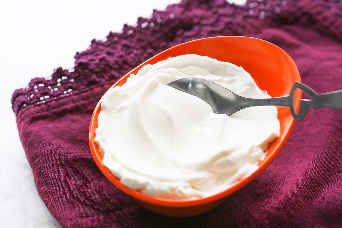 Top view of a small bowl filled with sour cream.