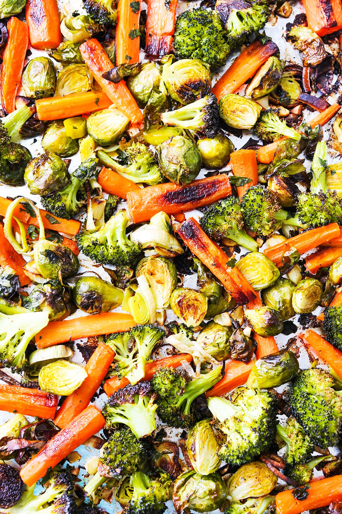  top view close up of roasted veggies such as broccoli and carrots.