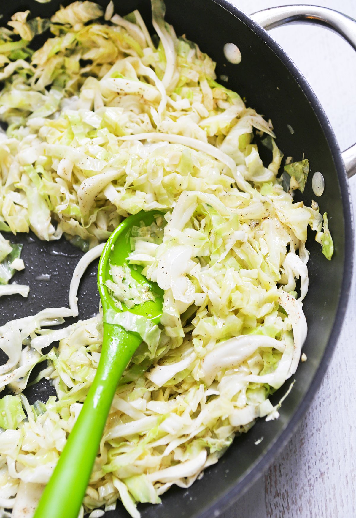 Top view of a pan of sauteed cabbage.