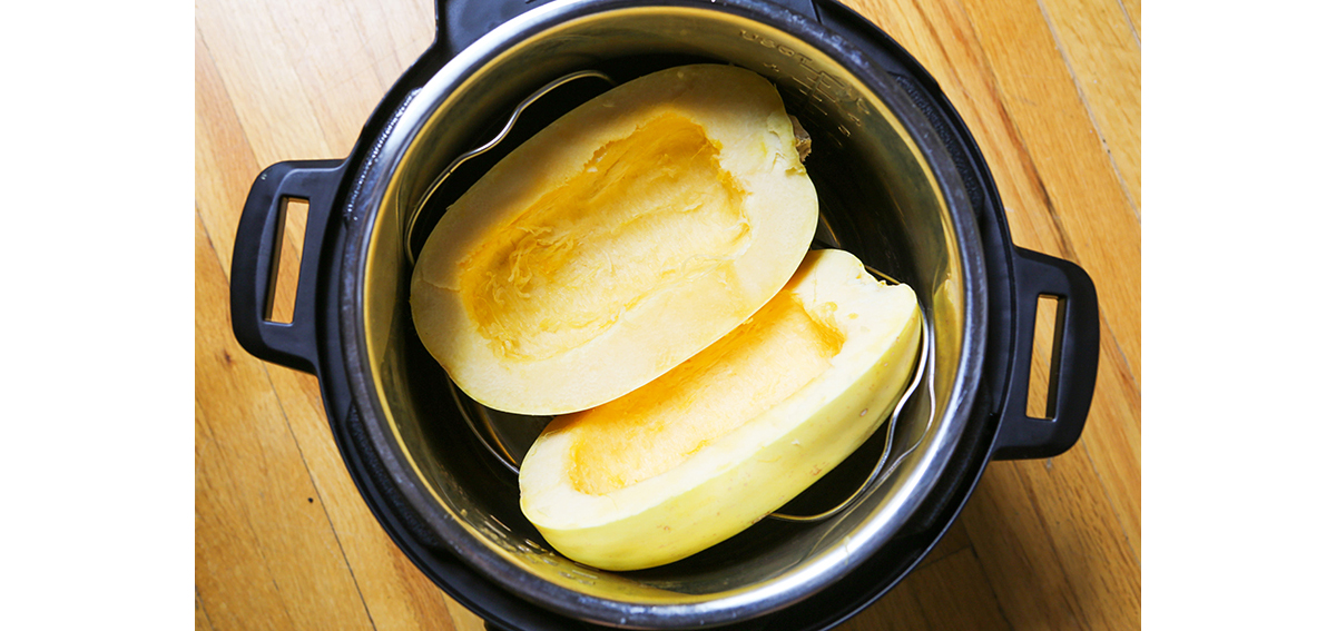 two halves of a spaghetti squash inside the instant pot.