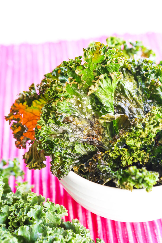 Kale chips with sea falt in a bowl.