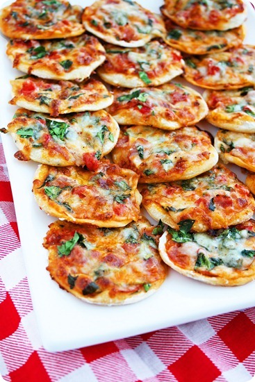 Serving platter with homemade mini pizzas. 