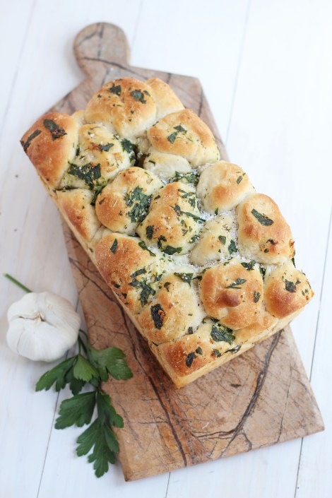 Pull apart bread on a cutting board. 