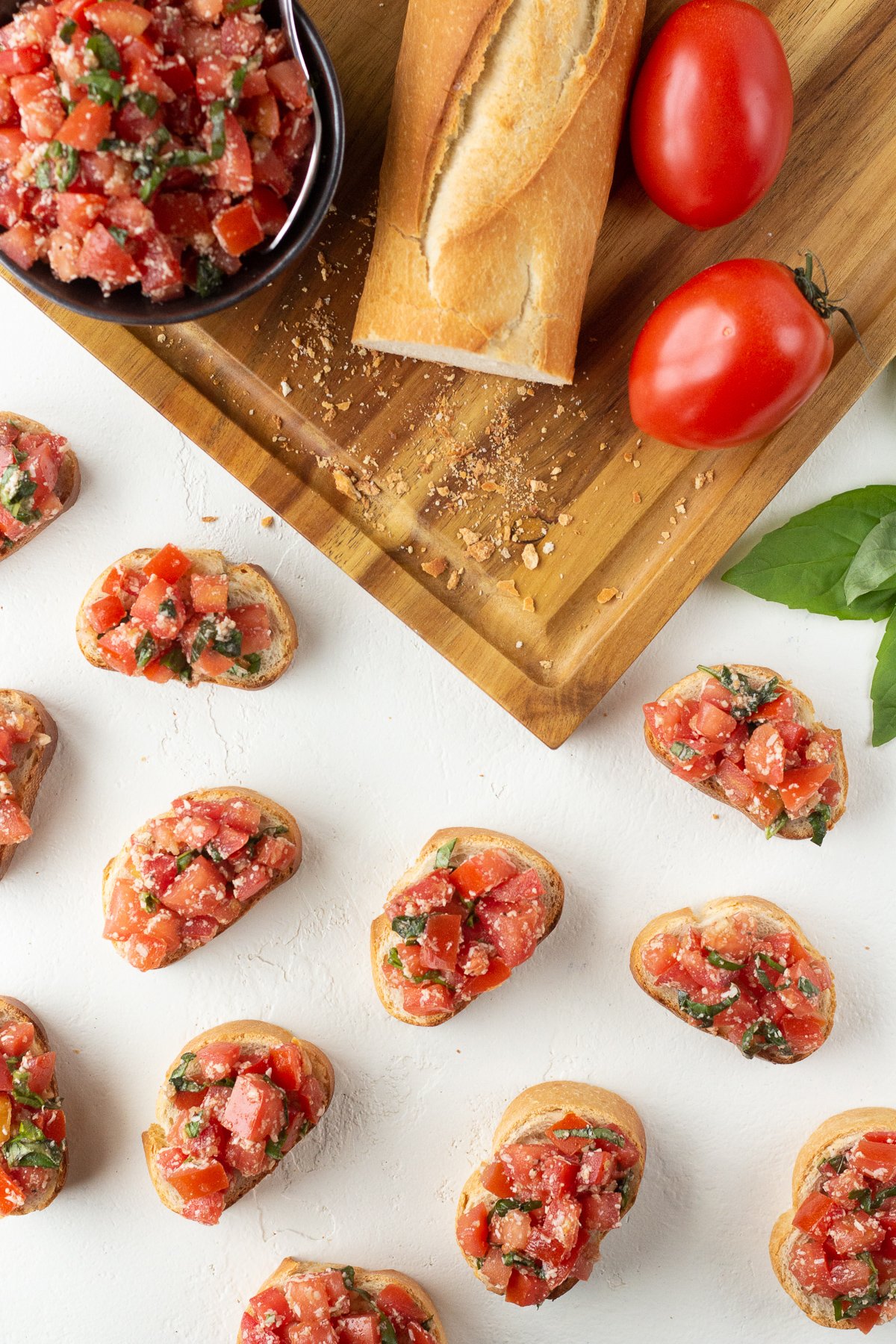 Top view of bruschetta lined up on a counter.
