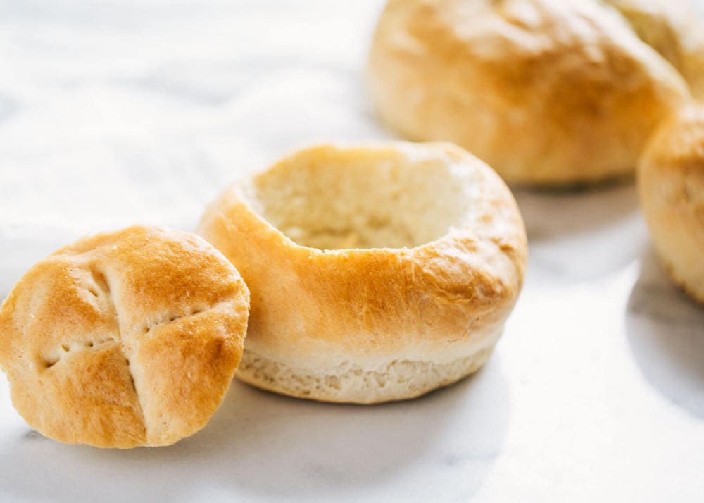 Homemade baked bread bowl with the top cut off. 