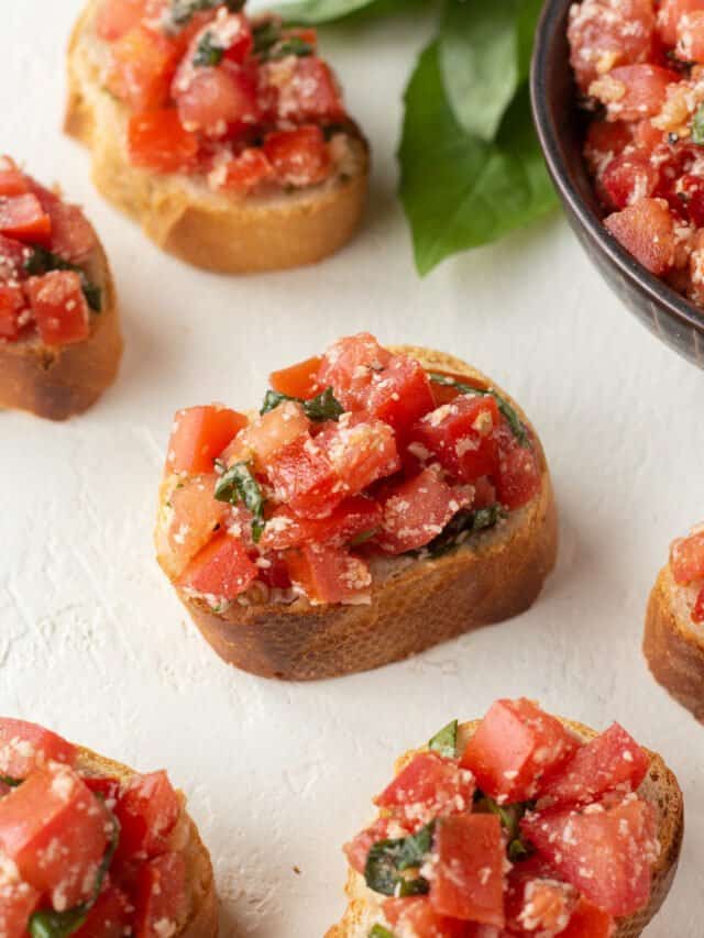 Pieces of balsamic bruschetta on a counter.