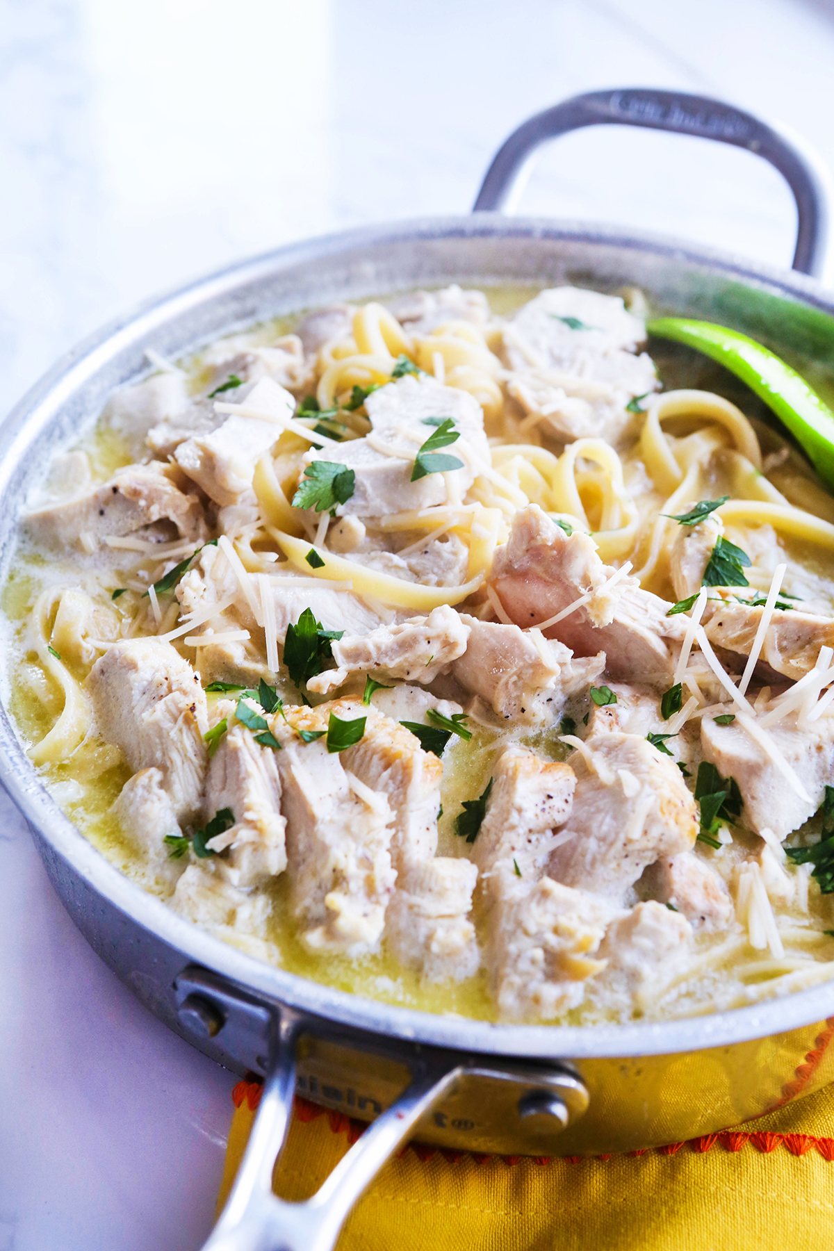 Skillet filled with alfredo pasta.