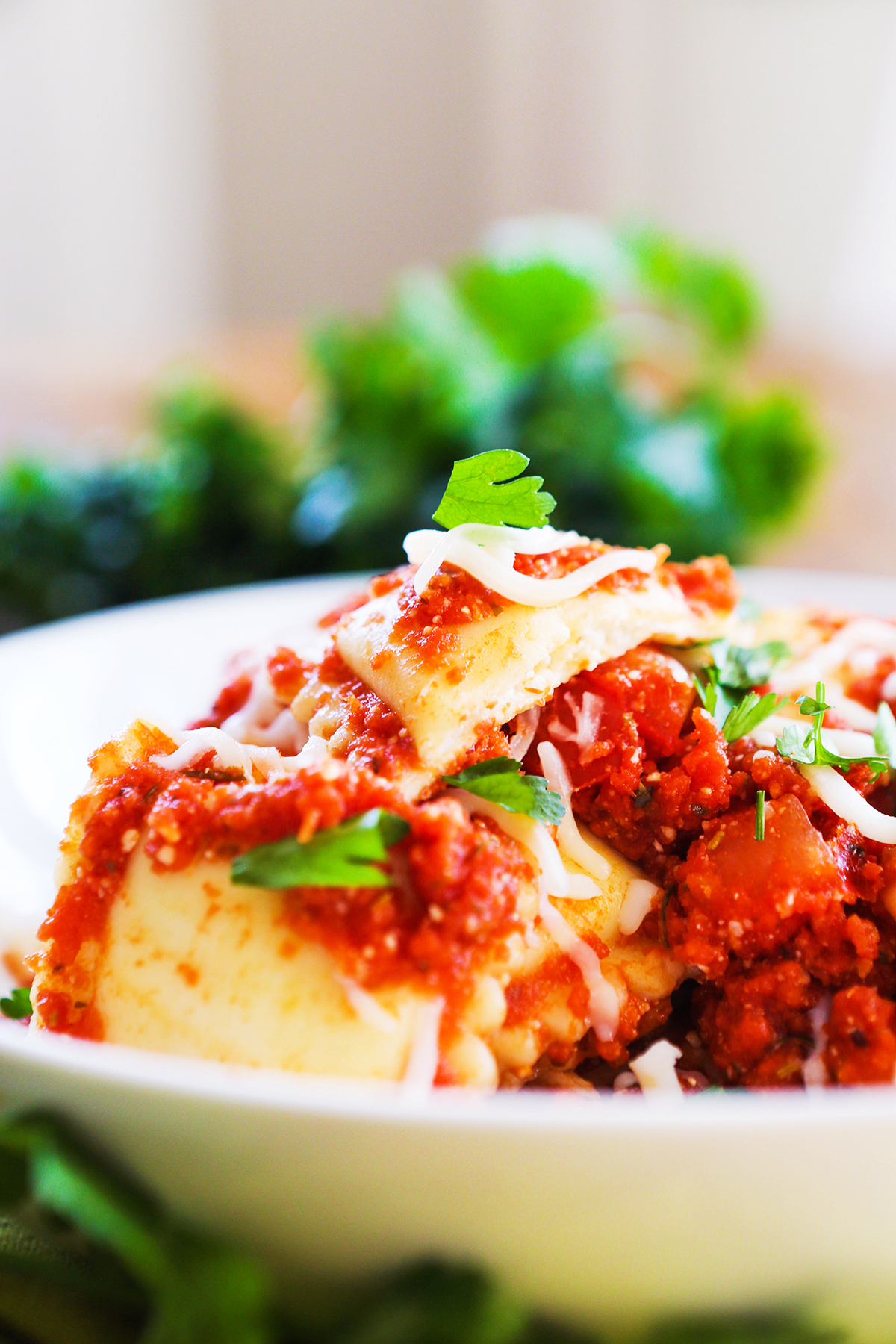 Heaping bowl of cheese ravioli with parsley.