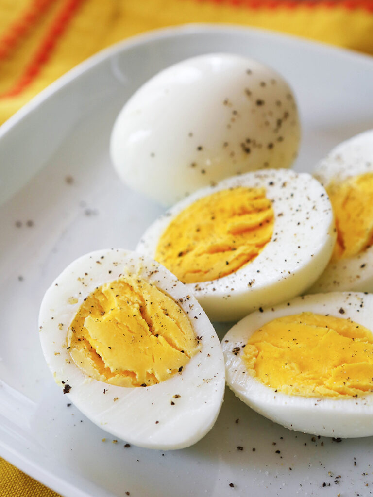 Instant Pot Hard Boiled Eggs halved and covered with black pepper. 