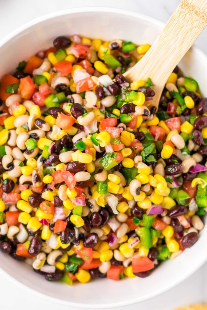 Cowboy caviar dip with a wooden spoon in it. 