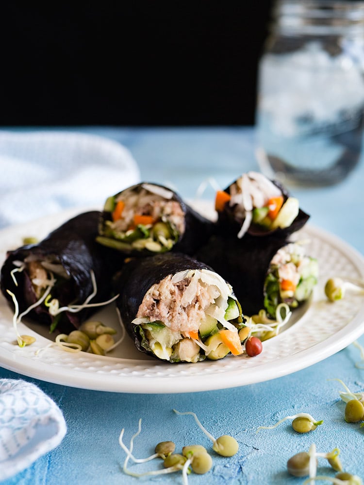 Nori wraps with sardines sprouts and sauerkraut on a plate. 