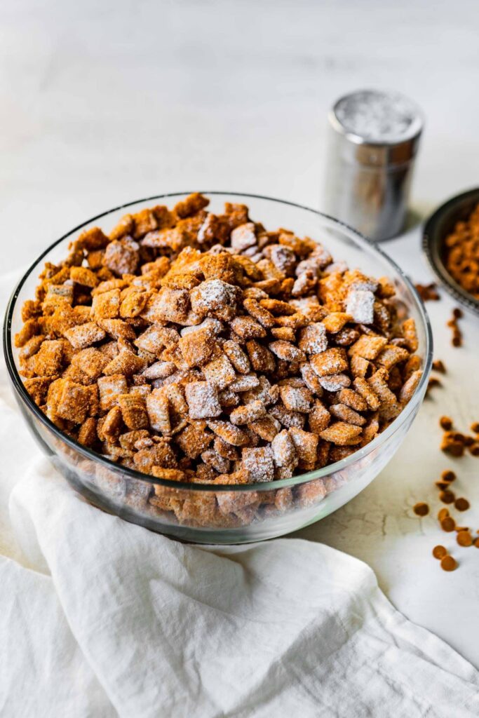 A big glass bowl of churro chex snack mix. 