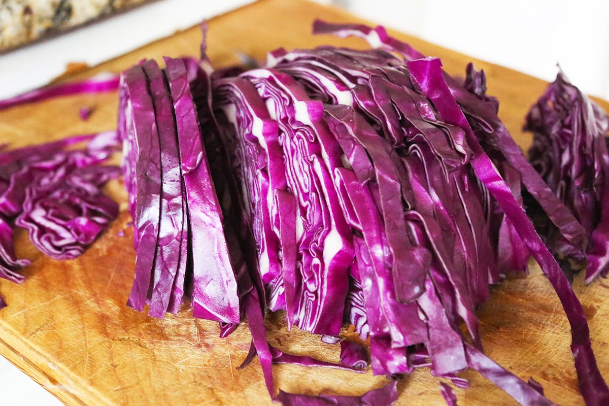 Shredded cabbage on a cutting board.