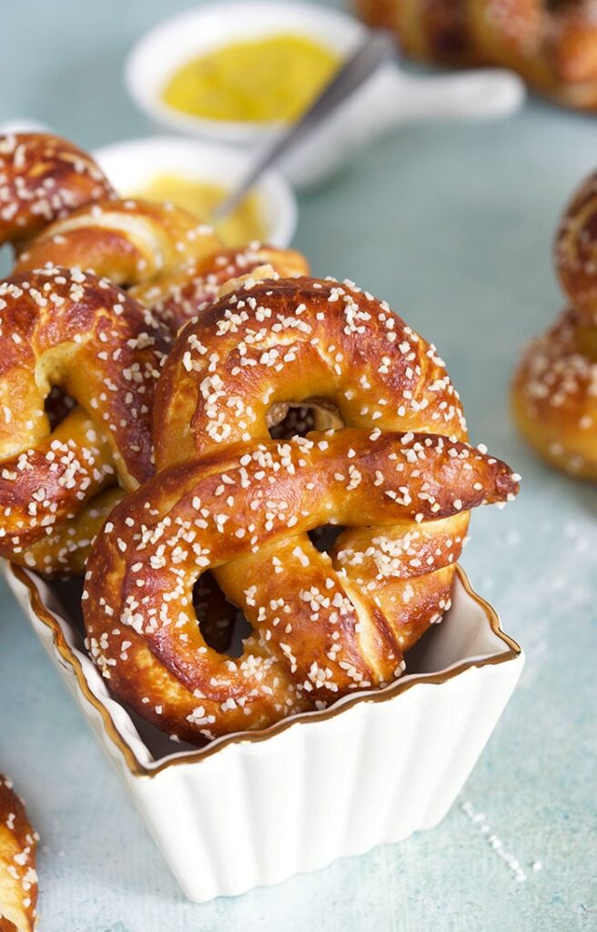 Square dish filled with big soft pretzels. 