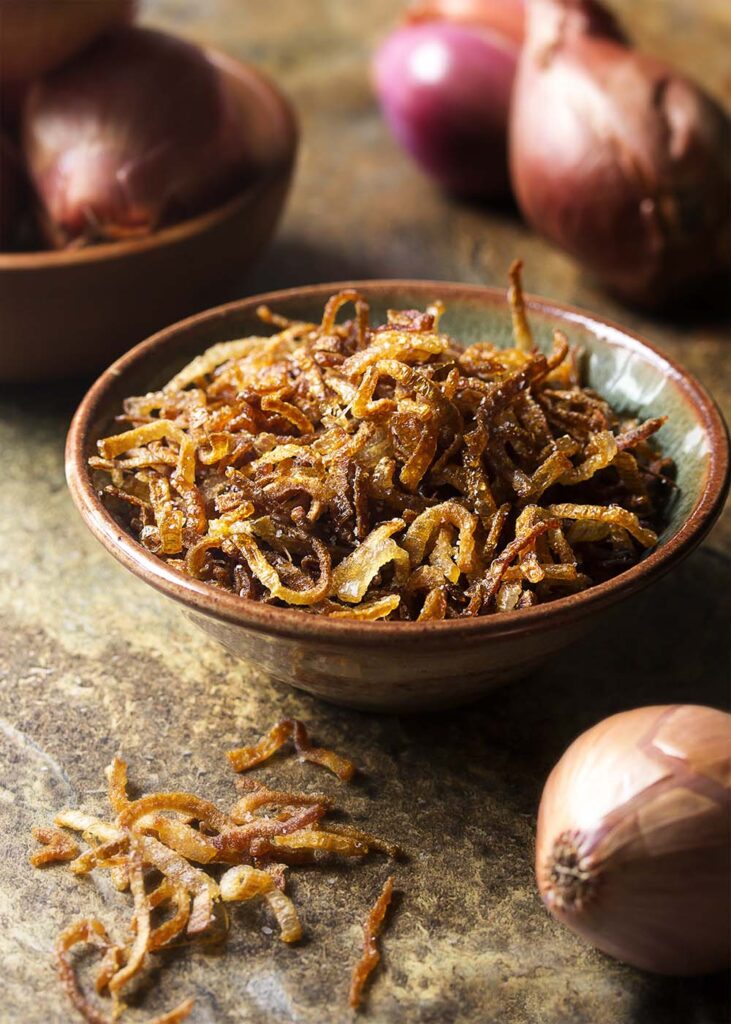 Crispy fried shallots in a small bowl. 