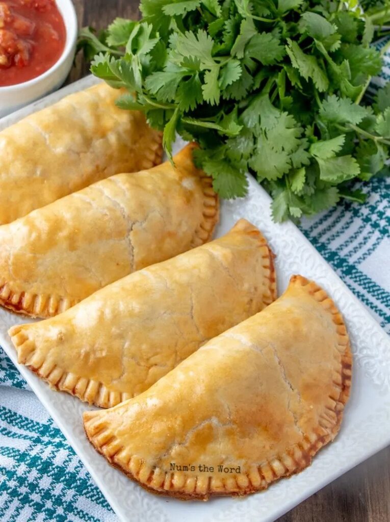 A white serving platter for 4 empanadas. 