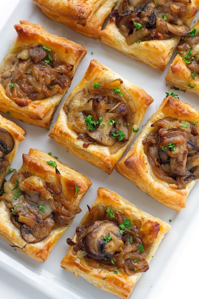 Gruyere, mushroom and caramelized onion bites cut into squares to be served. 