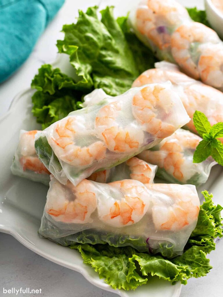 Fresh spring rolls served on a white platter. 