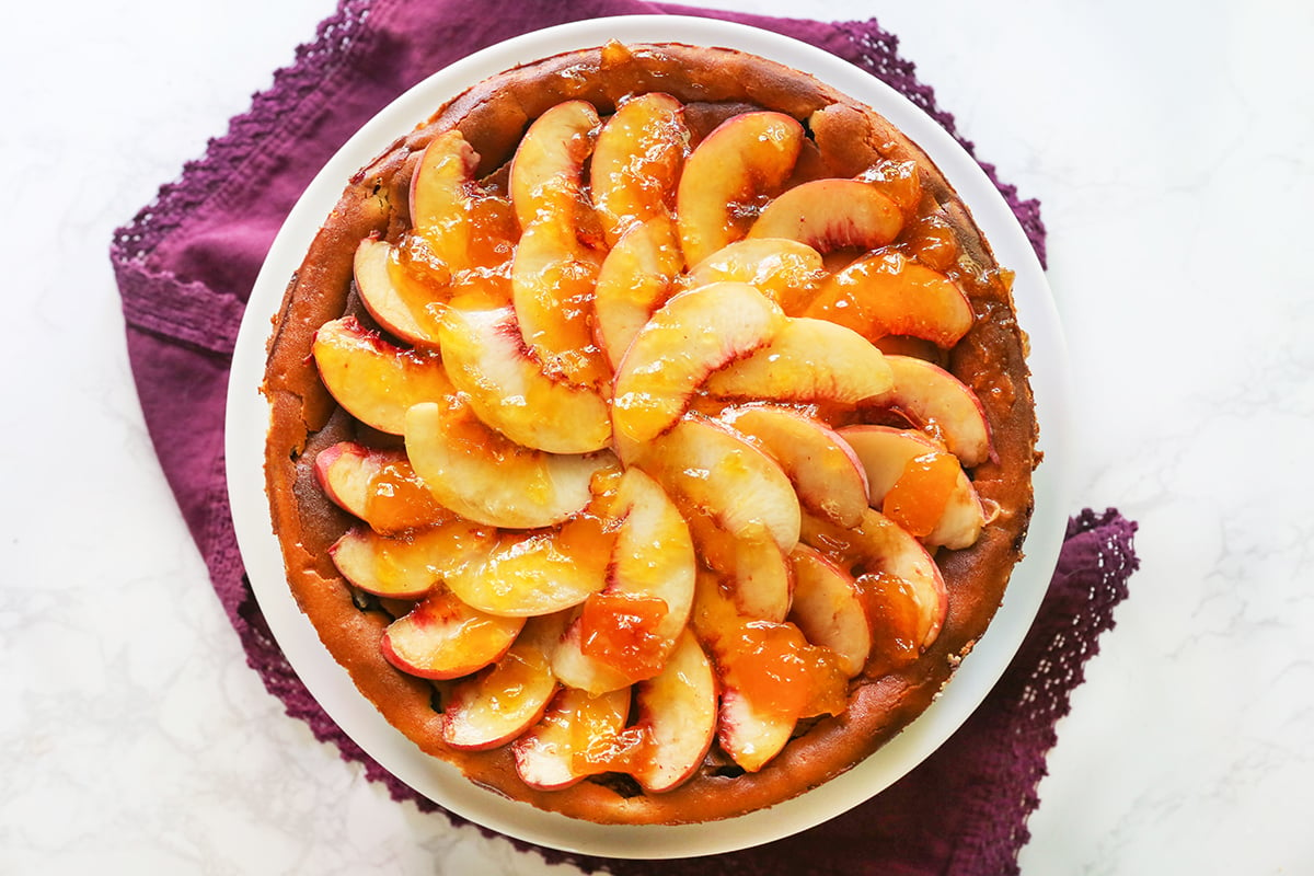 Top view of a peach-topped cheesecake.