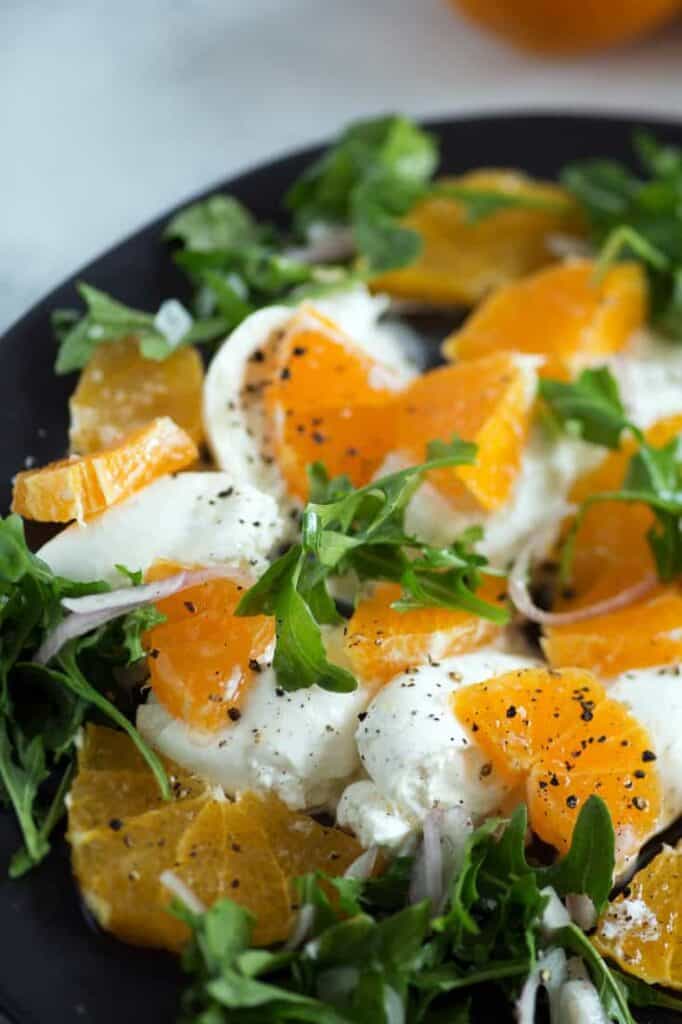 Burrata salad with oranges on a plate. 
